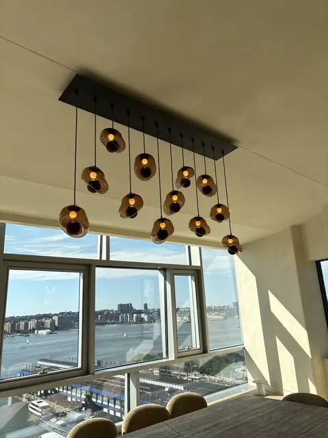 Pendant cluster over a dining table with river views